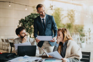A young couple considers health insurance options with an agent in Ada, MI