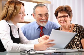 Agent reviewing Medicare Part D plans with an elderly couple in Plainfield, MI